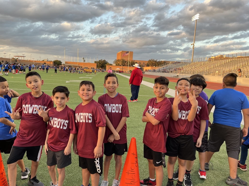 Alma Pierce Cross Country Cowboys hang out on the field before the race.